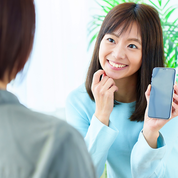 モデルハウスを知人に紹介する女性